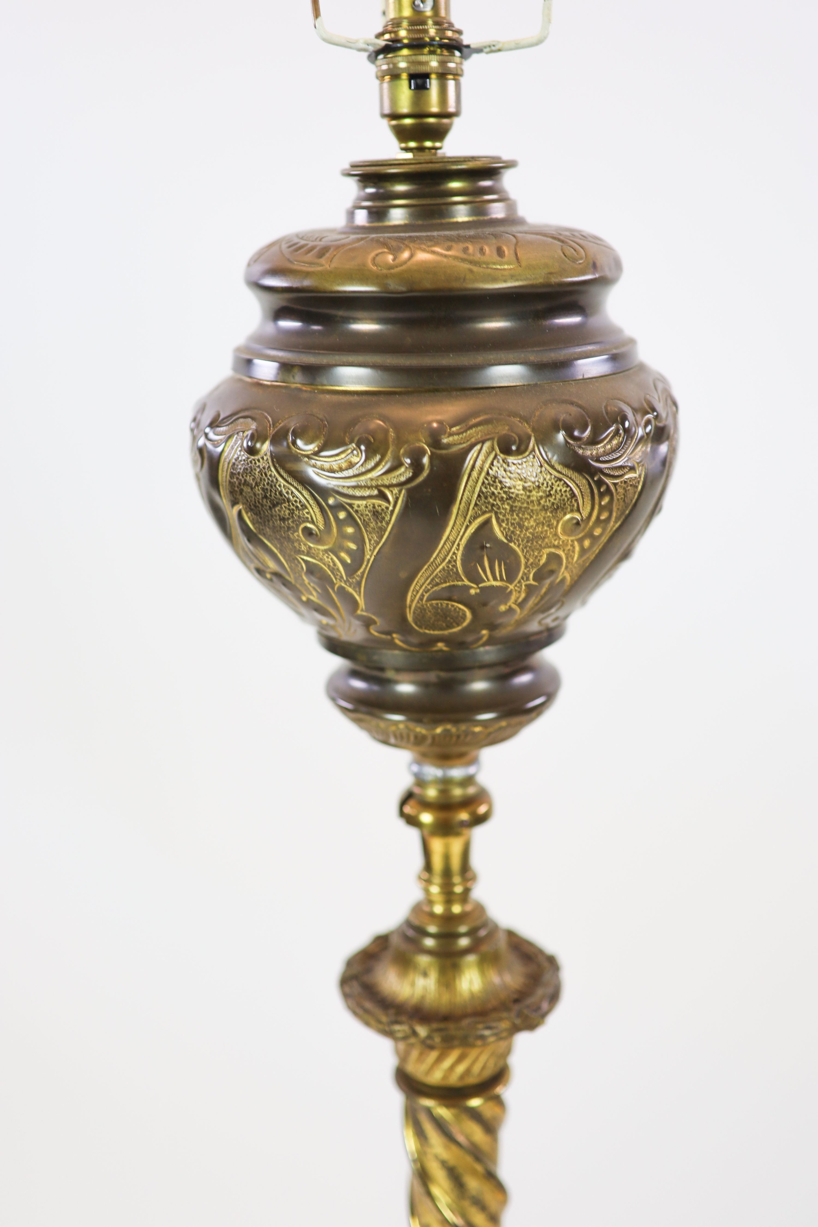 A late Victorian cast brass lamp standard, the column with an alabaster mid tier, raised on an open scrolled tripod base, converted to electricity, height 152cm